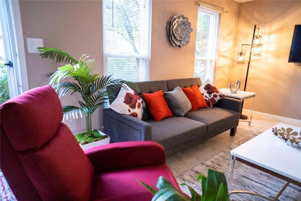 a living room with furniture and a large window