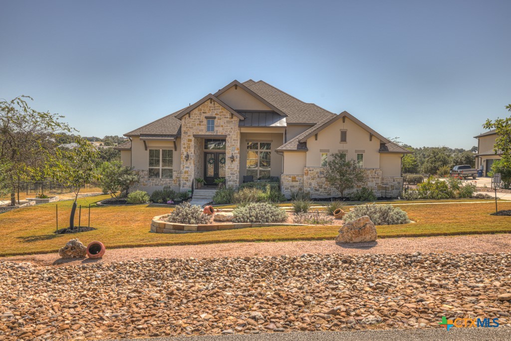 a front view of a house with a yard