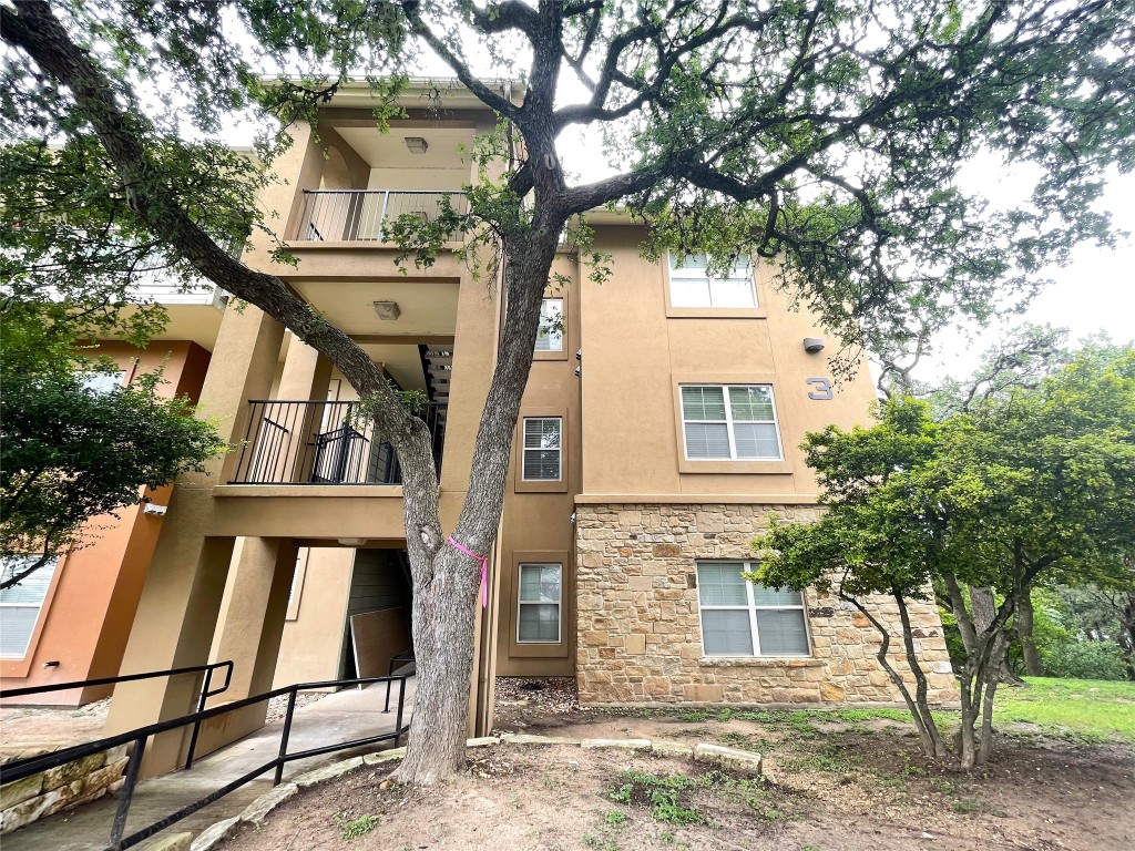 a view of a house with a tree