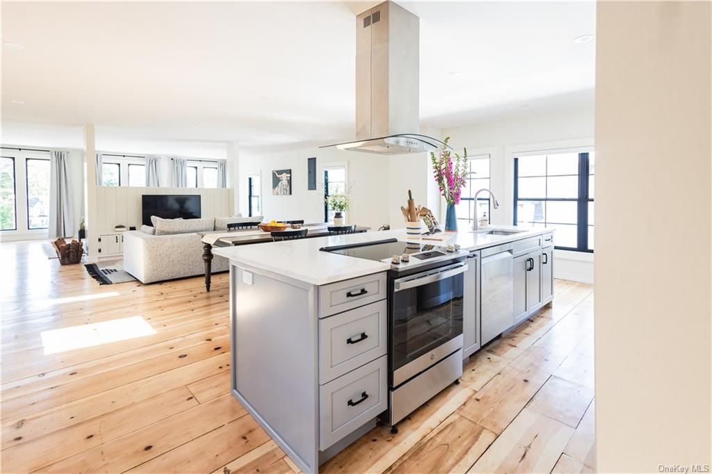 a kitchen with a stove a sink and a microwave