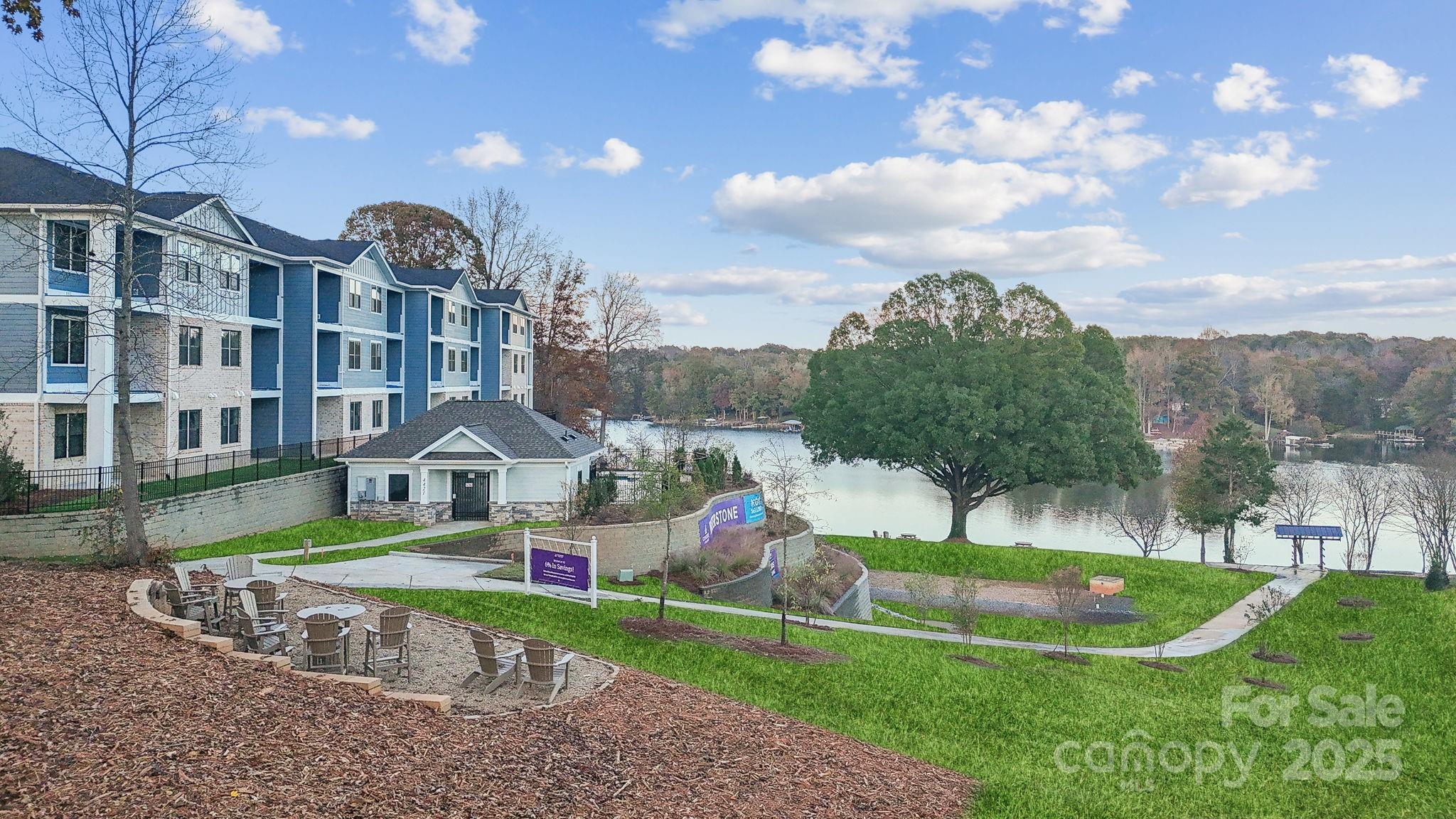 a front view of a house with a yard and lake view