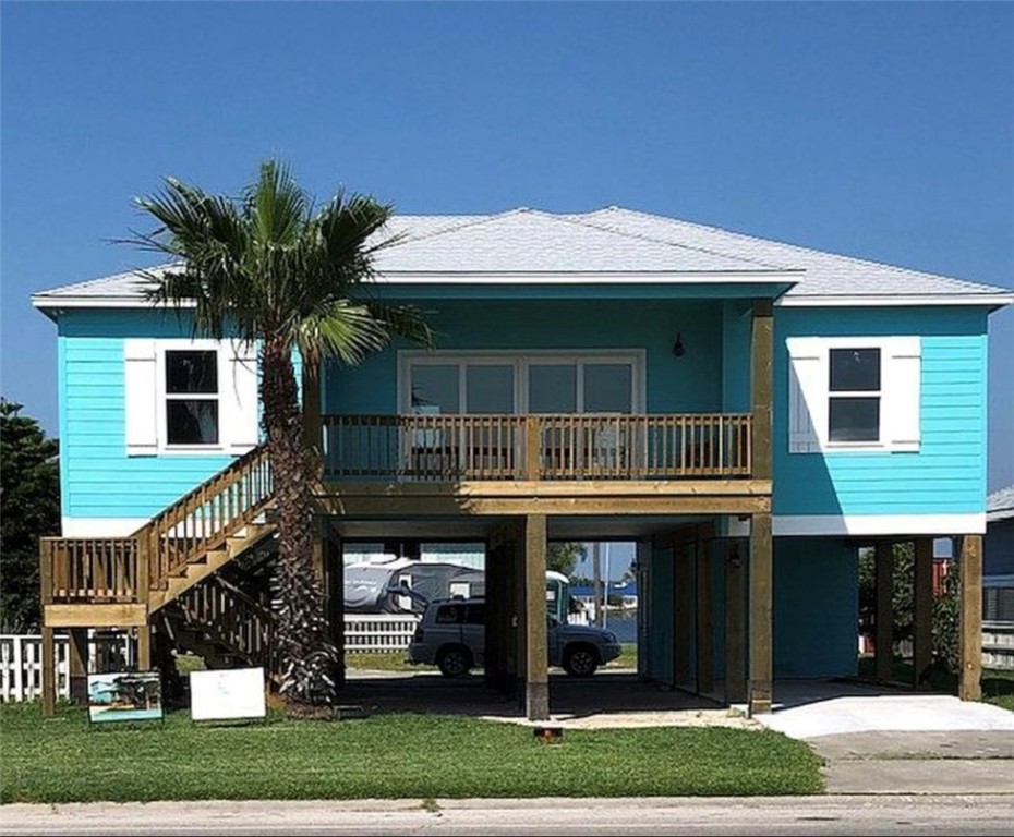 a view of house with a swimming pool and a yard