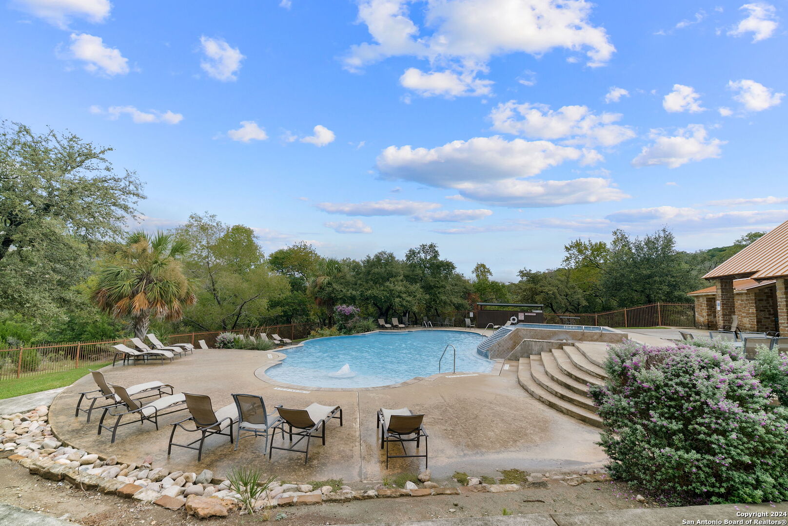 a view of a backyard with sitting area