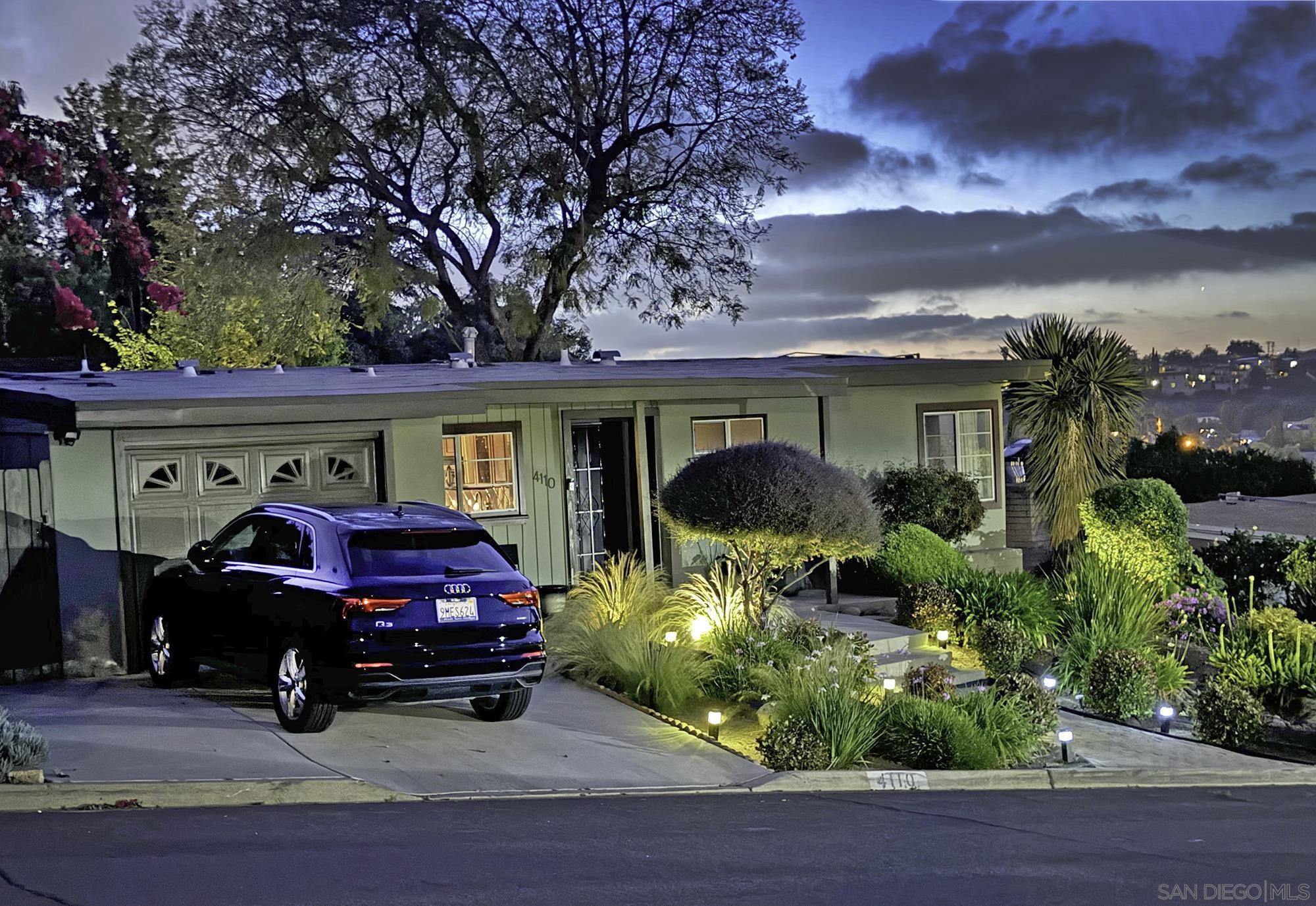 a view of a car parked in front of a house