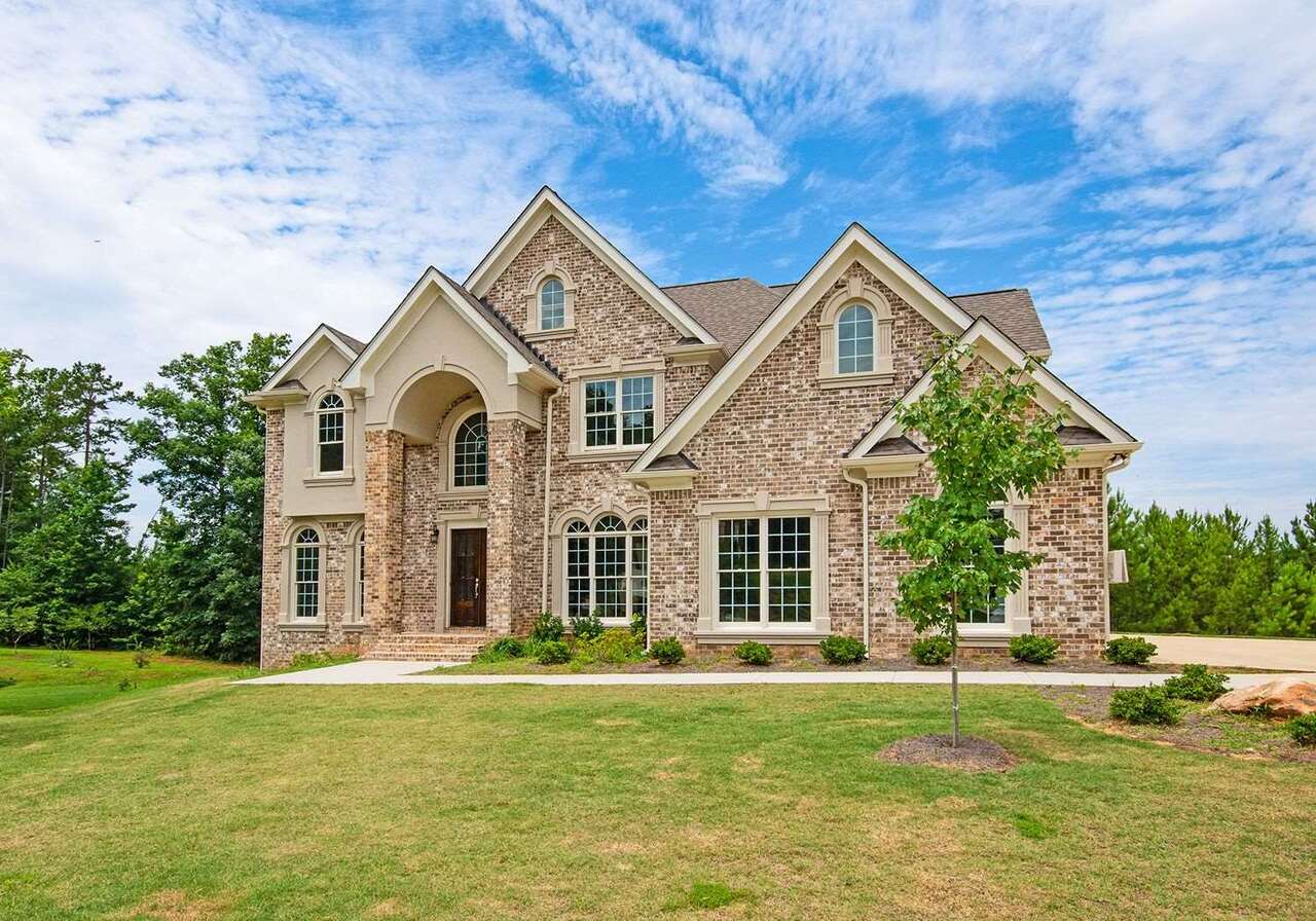 a front view of a house with a yard