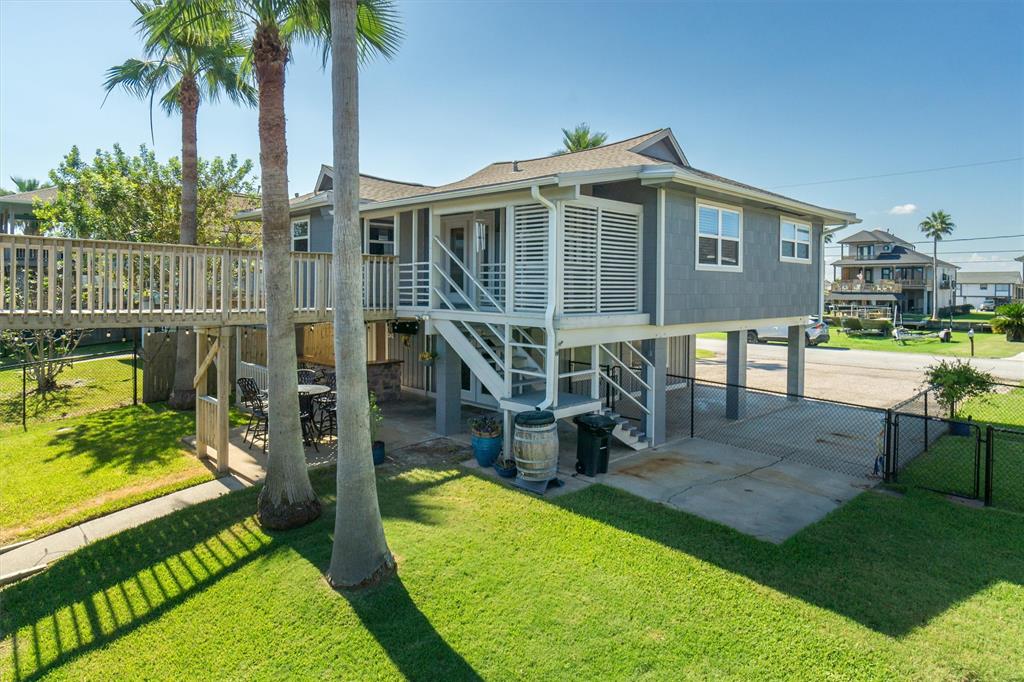 a view of a house with backyard porch and sitting area