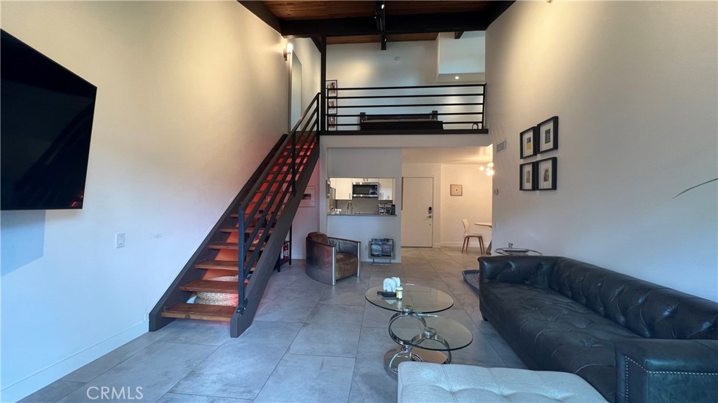 a living room with couches and a flat screen tv