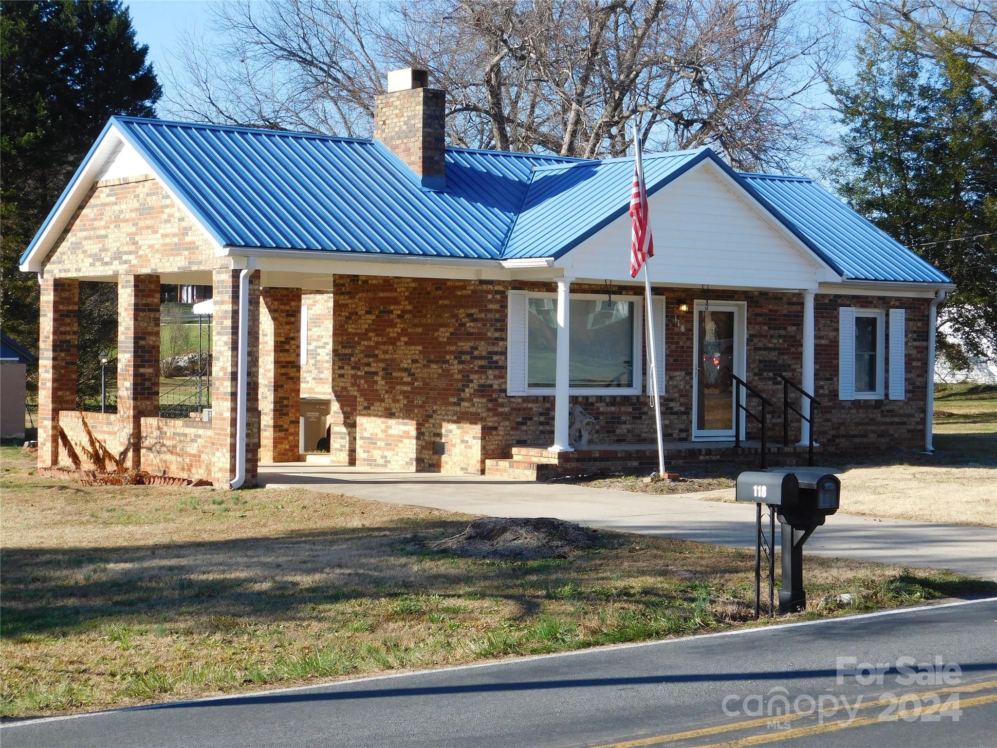 a view of a house with a swimming pool and sitting area