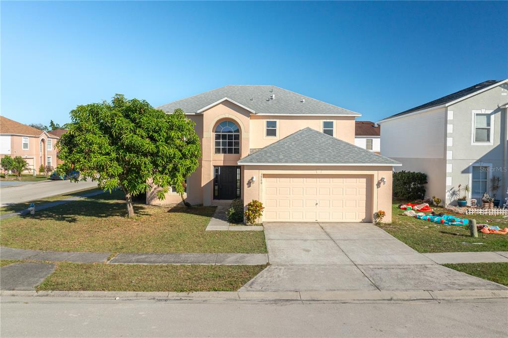 a front view of a house with a yard and garage