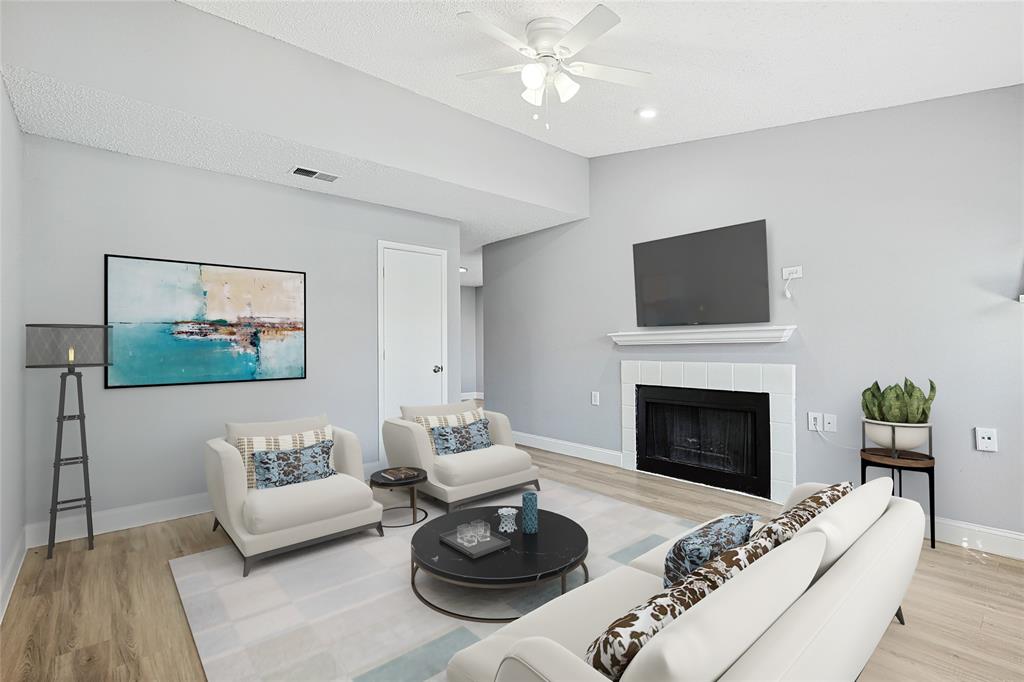 a living room with furniture a fireplace and a flat screen tv