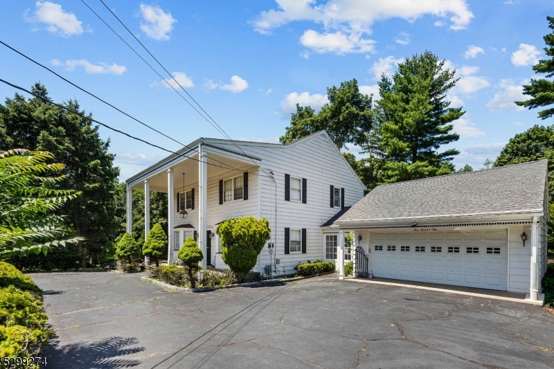 a view of a house with potted plants and a yard