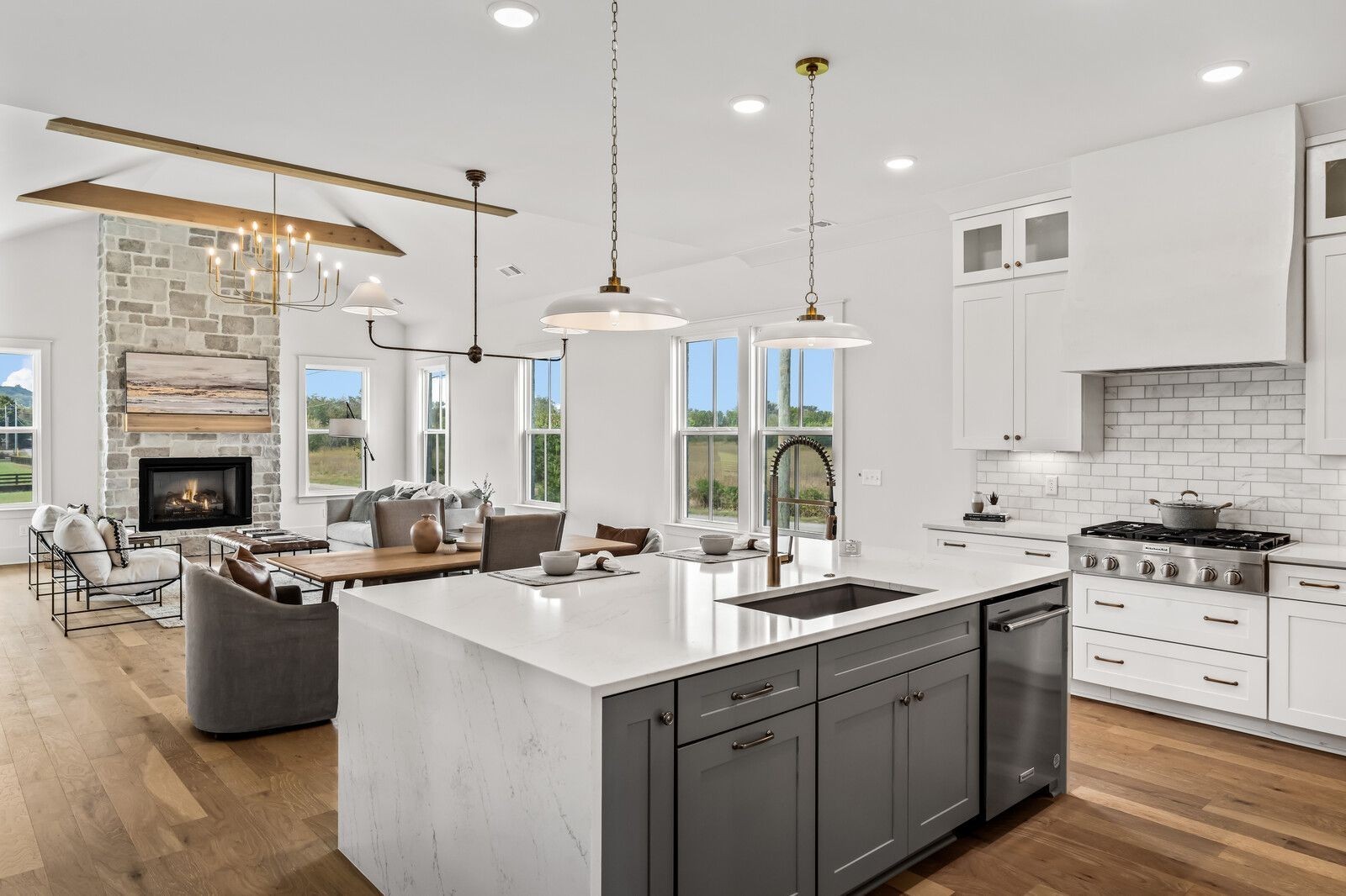 a kitchen with stainless steel appliances a sink a stove a refrigerator and cabinets