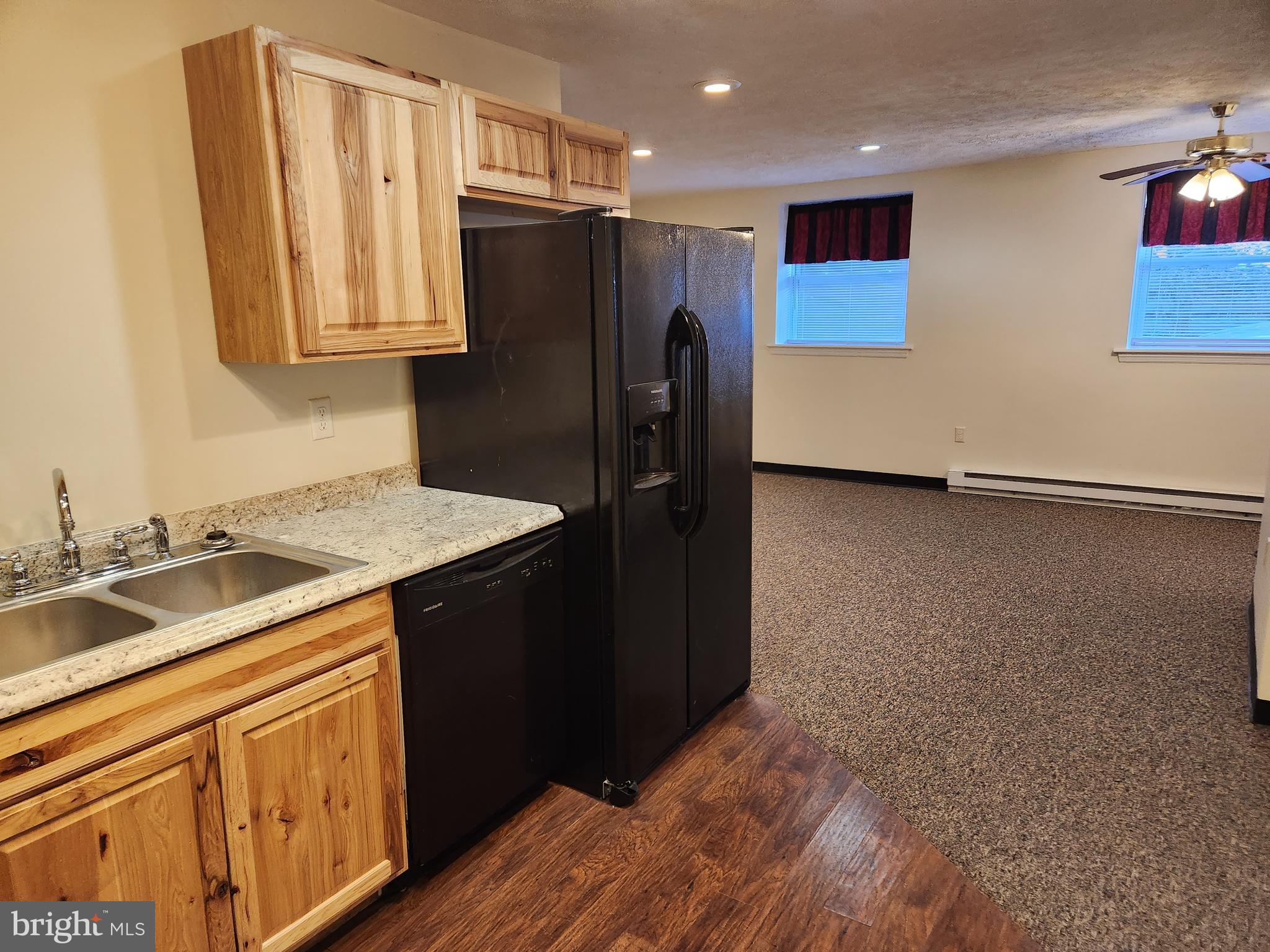 a kitchen with stainless steel appliances granite countertop a refrigerator and a sink