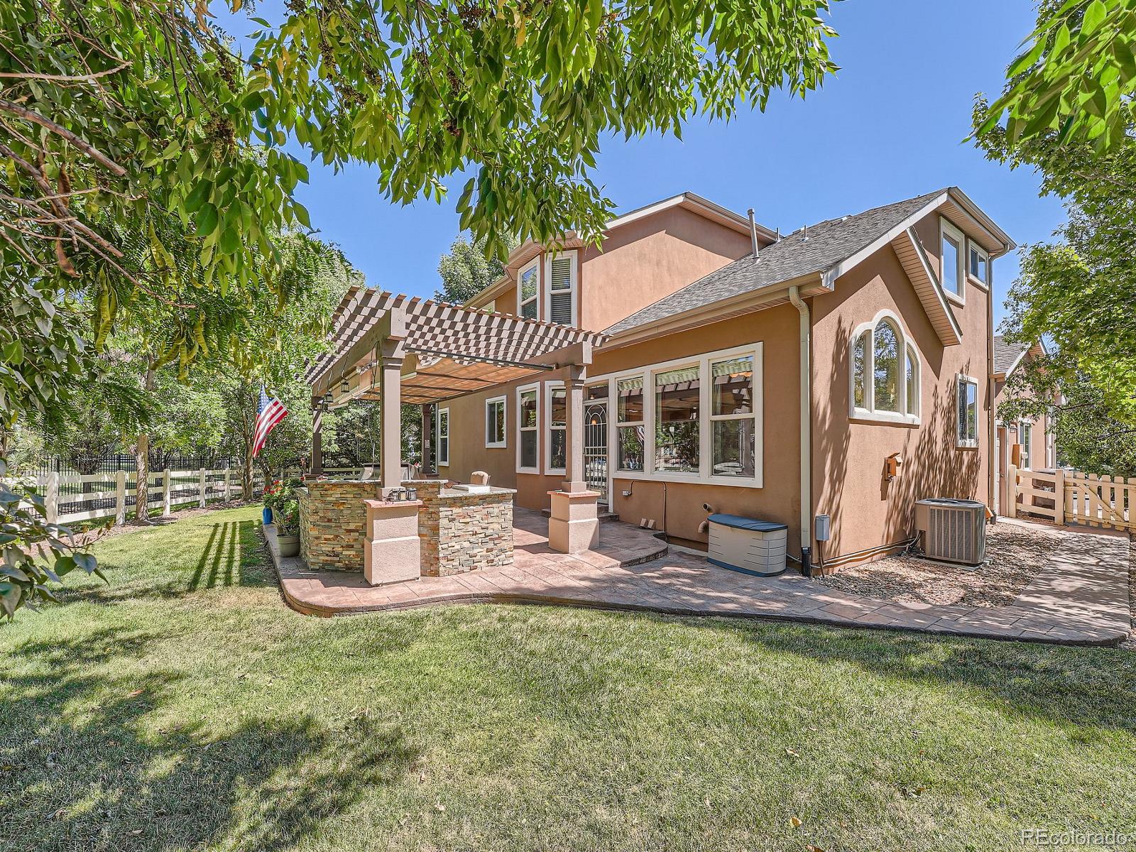 a front view of a house with a yard porch and furniture