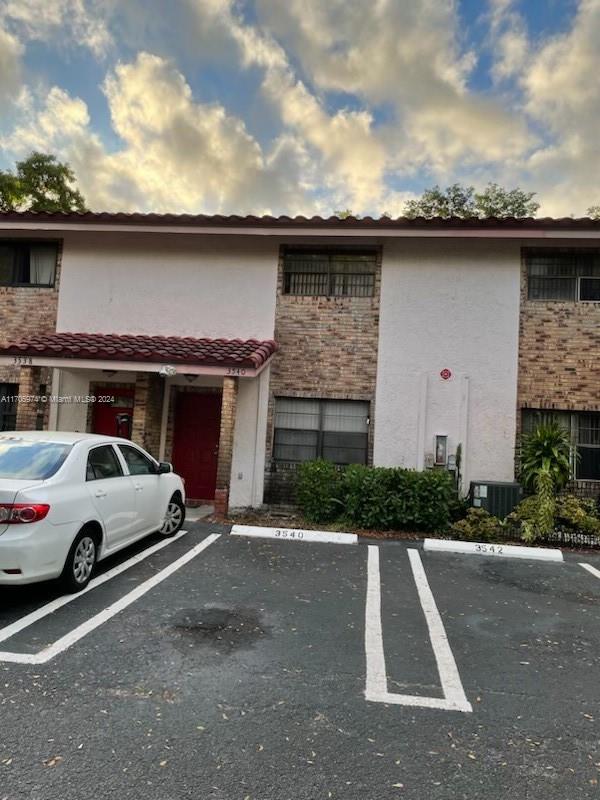 a view of garage with a car parked in it