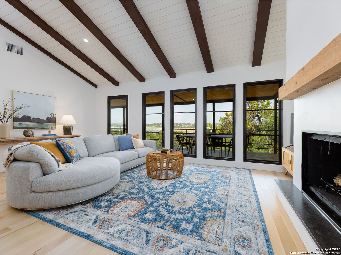 a living room with furniture and large windows