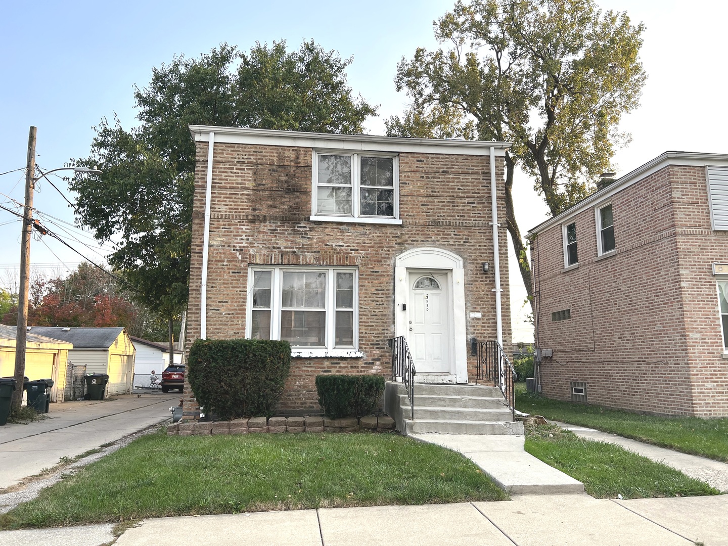 a front view of a house with a garden and yard