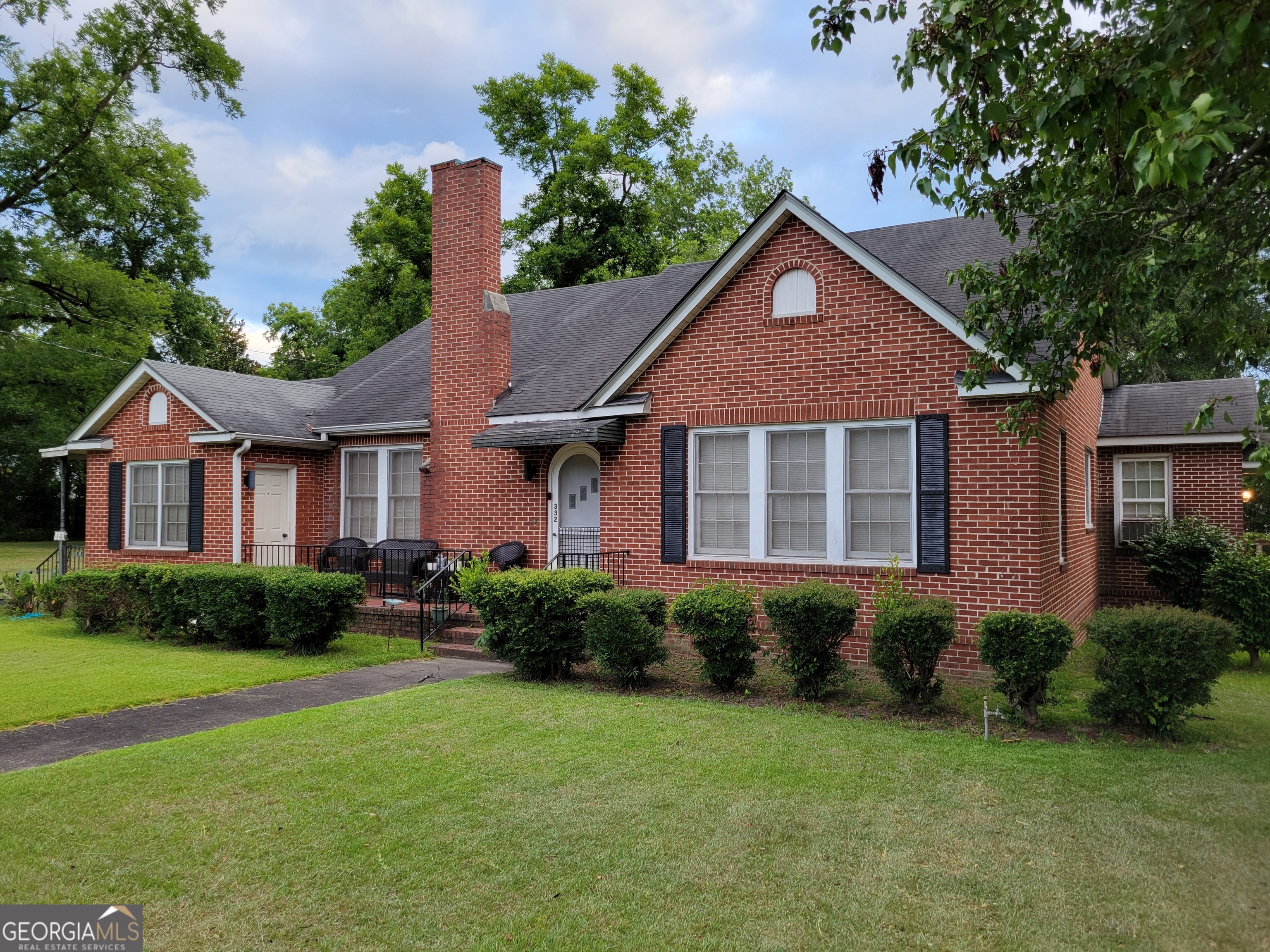 a front view of a house with garden