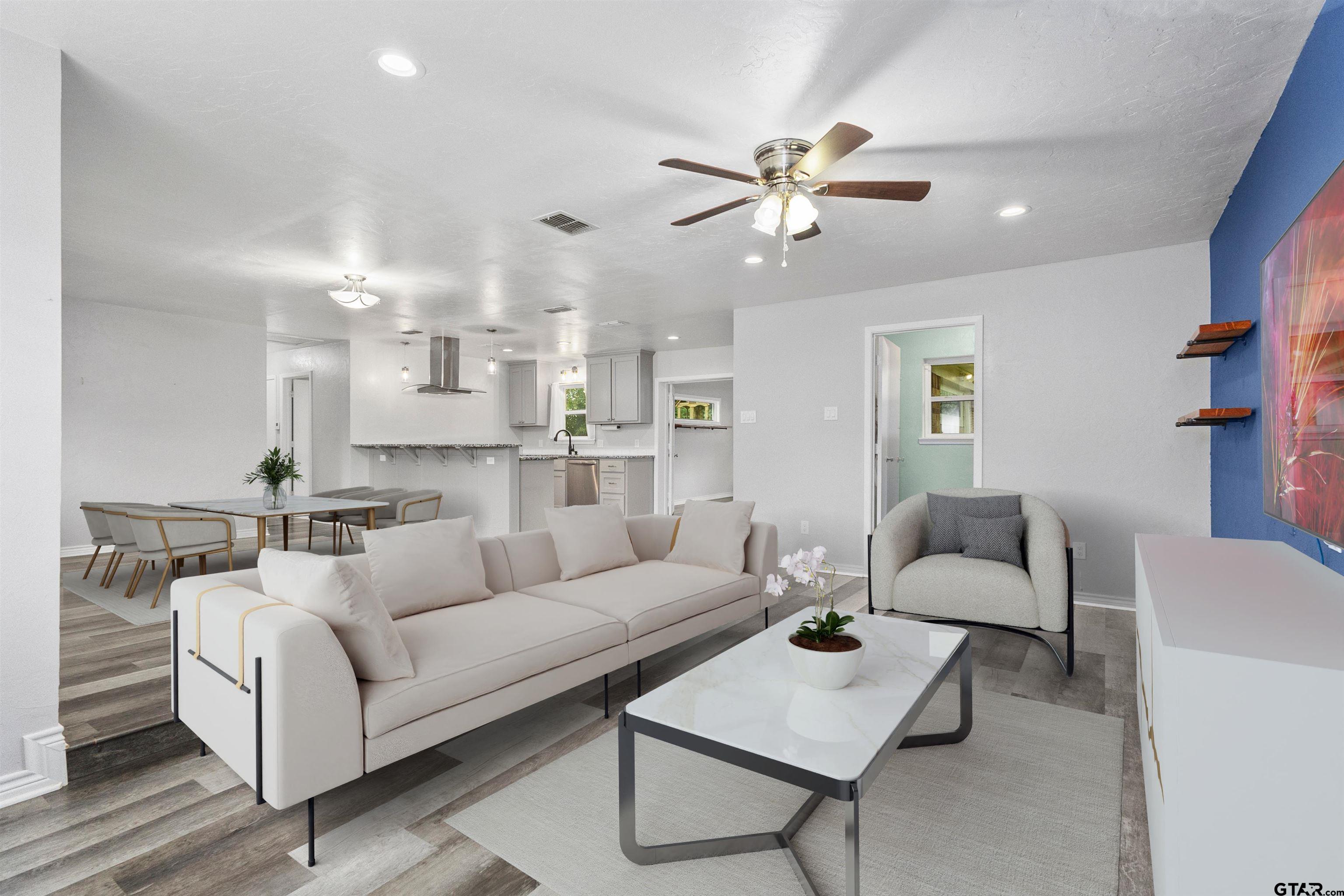 a living room with furniture and a chandelier