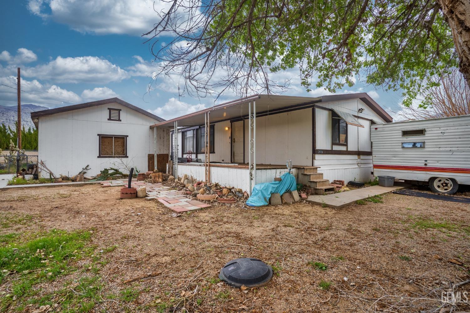 a view of a house with backyard and sitting area