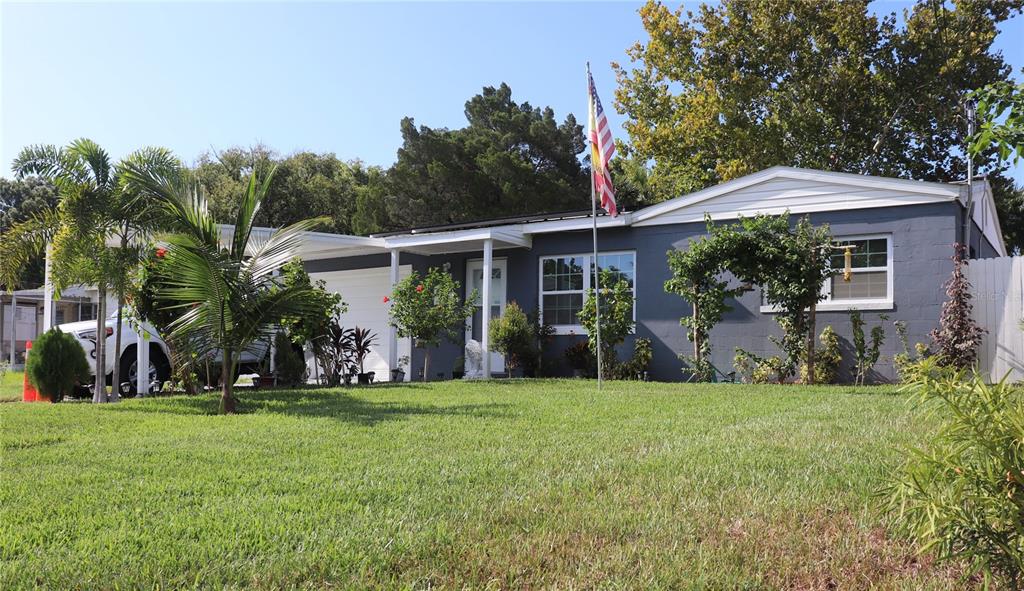 a view of a house with a yard porch and sitting area