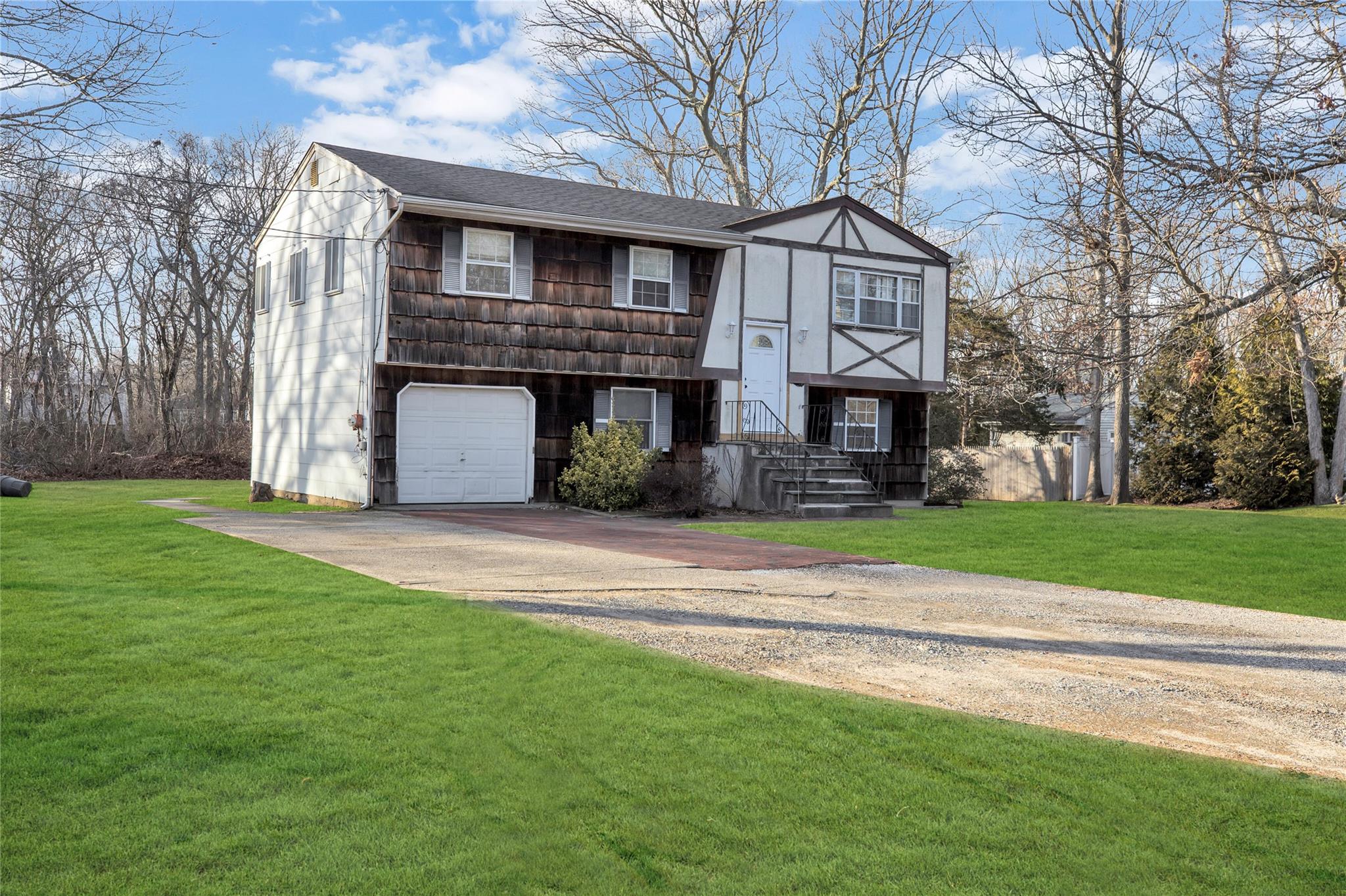 View of front of home featuring a front lawn and a garage