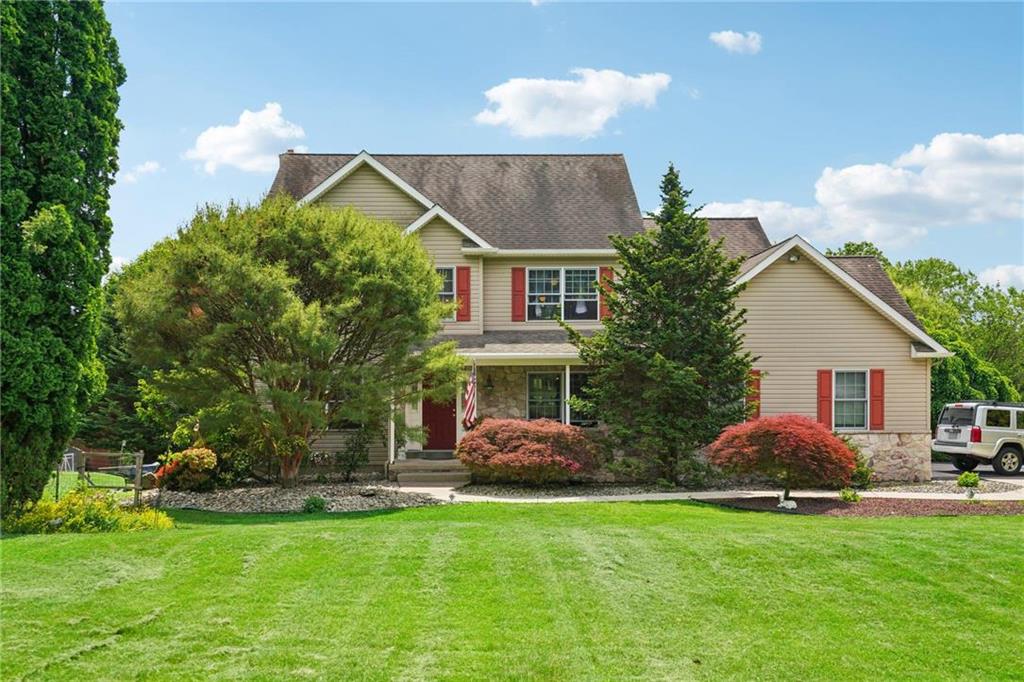 a front view of house with yard and outdoor seating