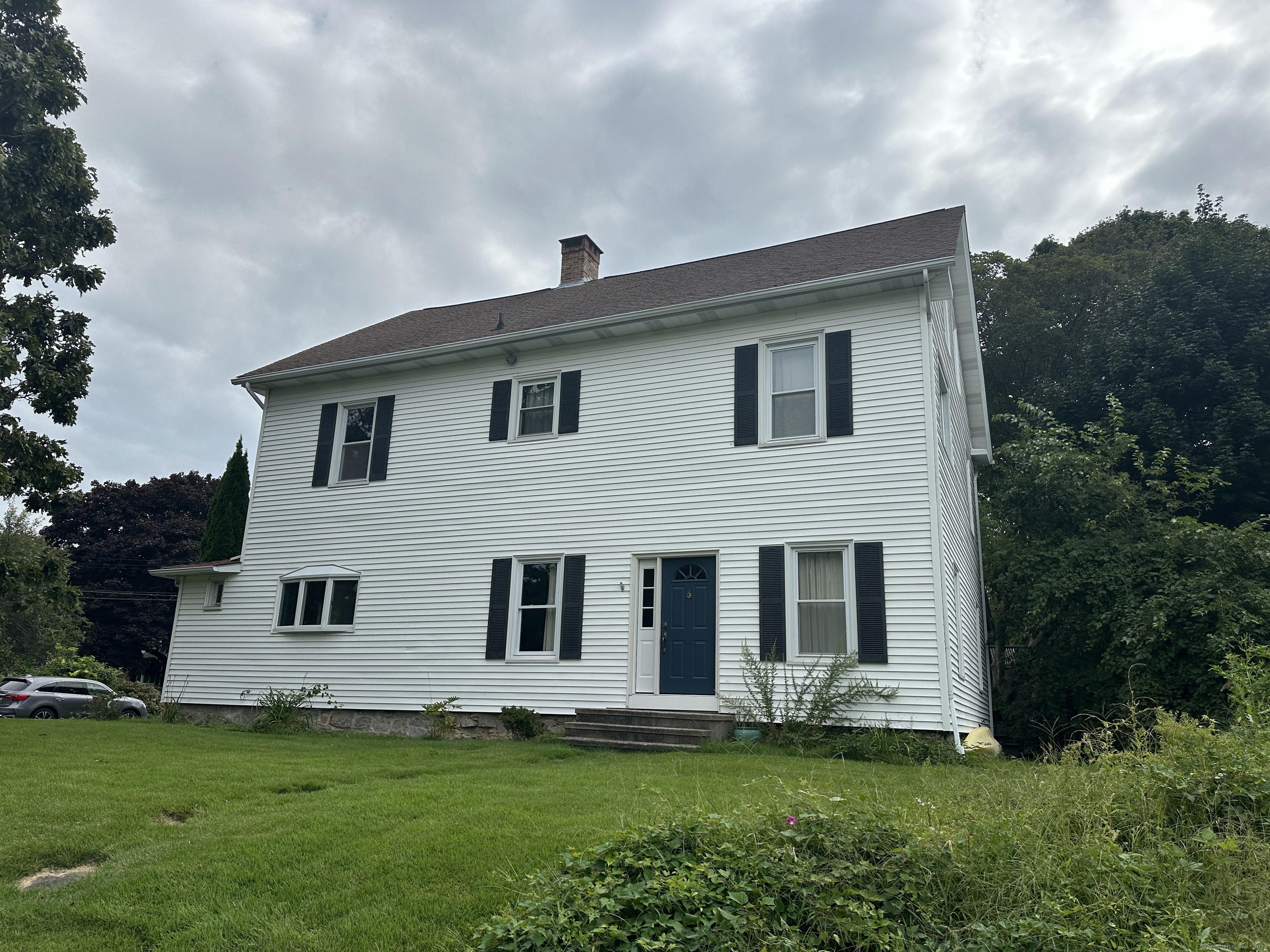 a front view of a house with a garden