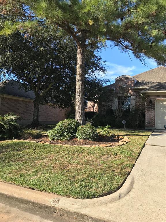 a view of a house with a tree in front of it