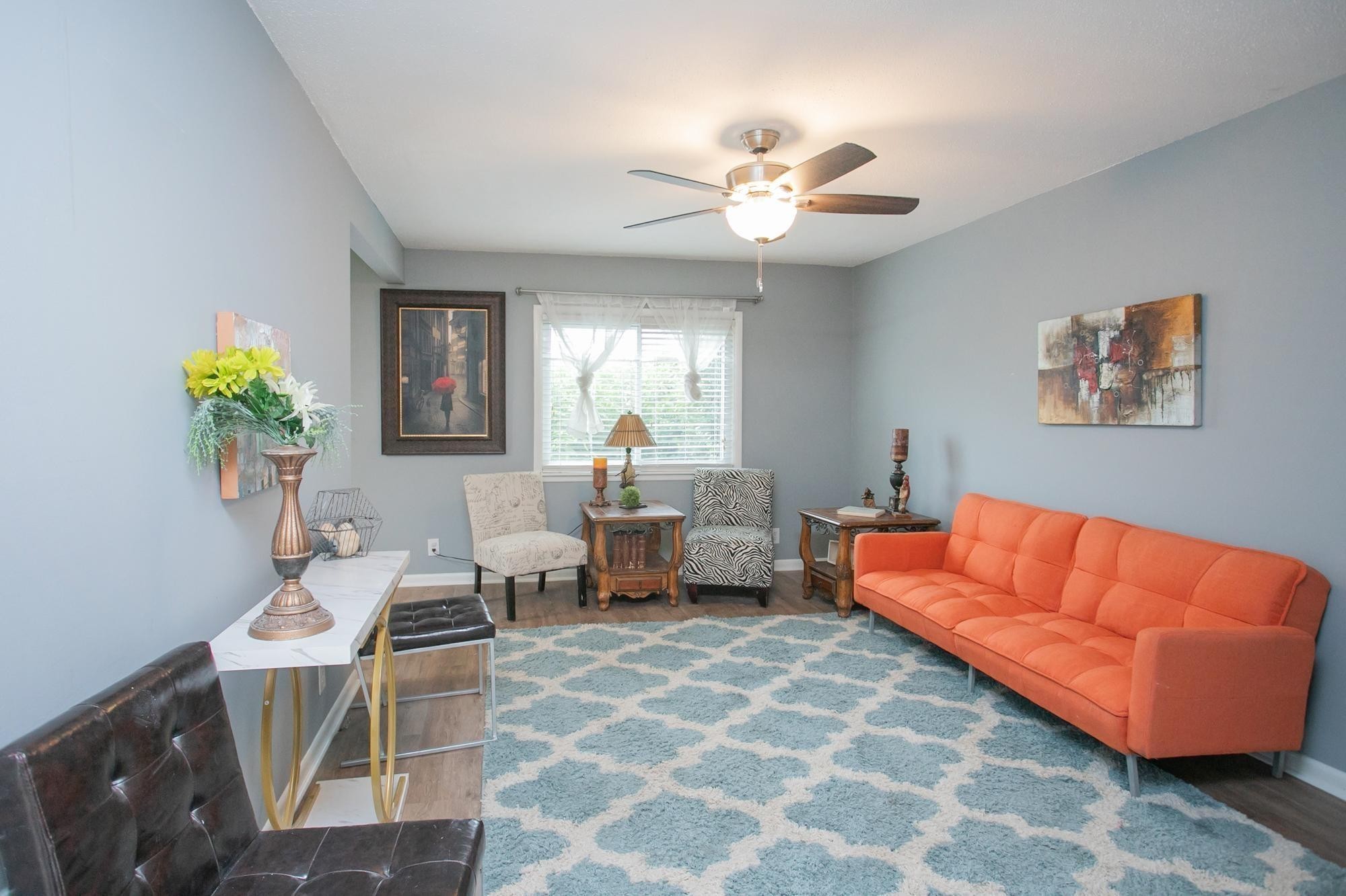 a living room with furniture and a chandelier