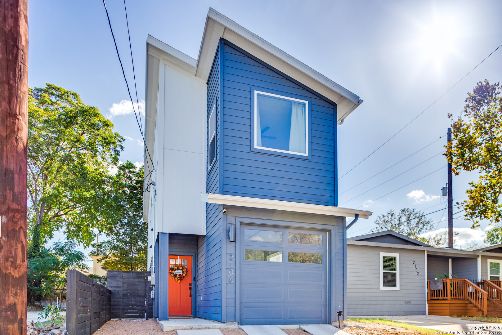 a view of a house with a garage and balcony