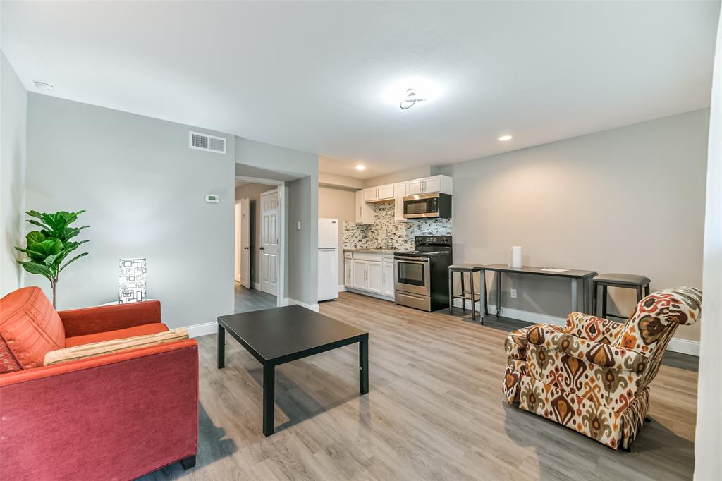 a living room with furniture and kitchen view