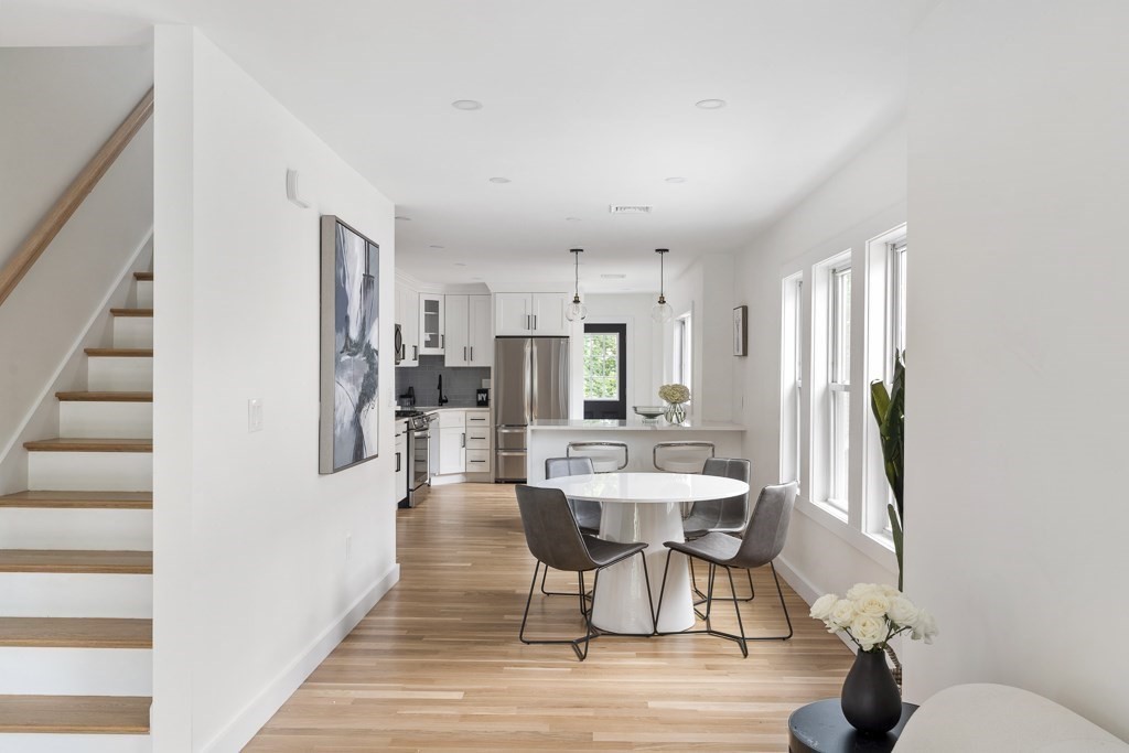 a view of a dining room with furniture and wooden floor