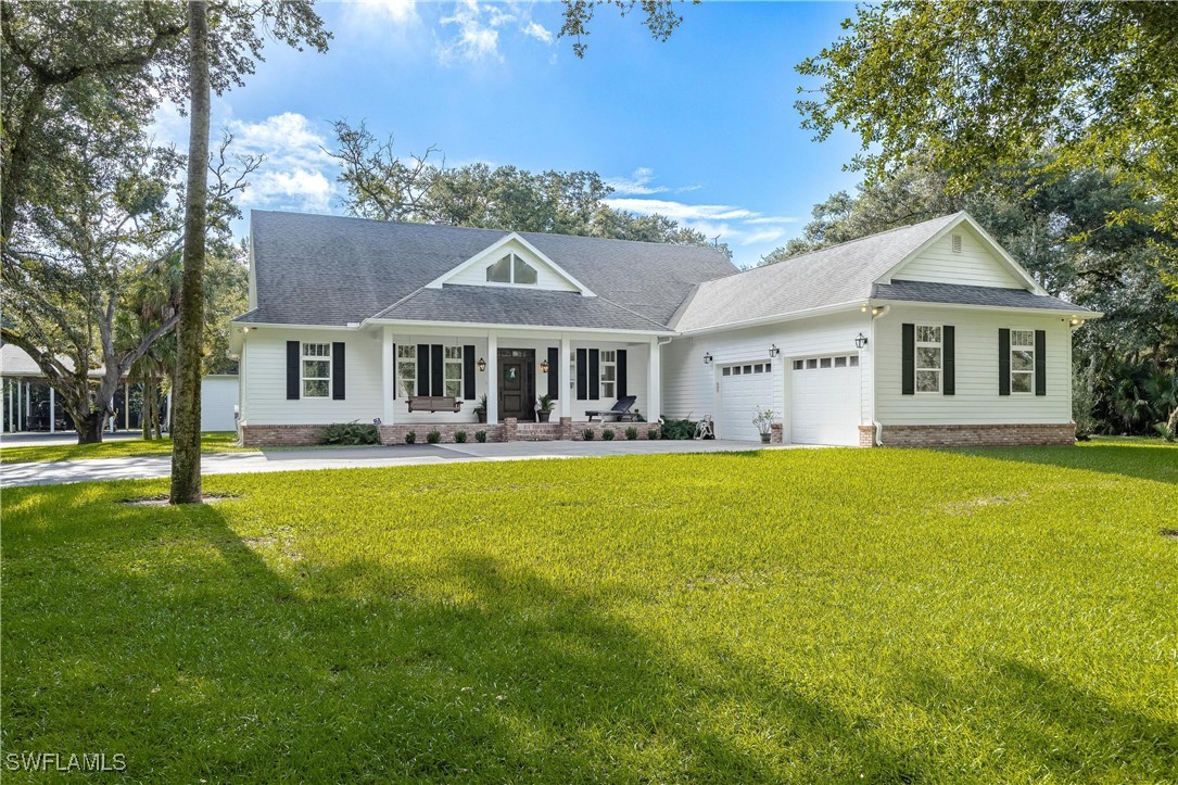 a front view of a house with swimming pool having outdoor seating