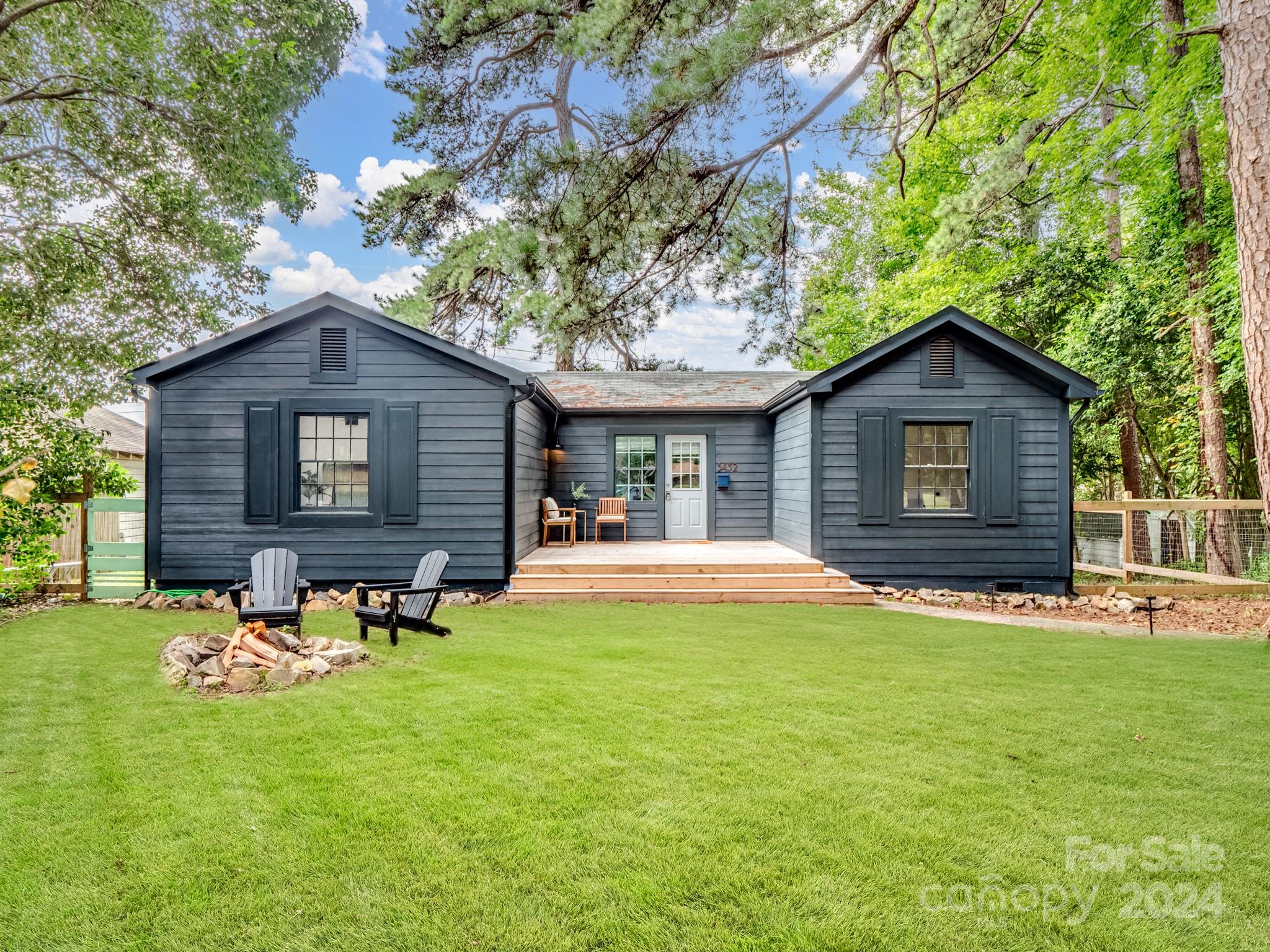 a view of a house with a yard and sitting area