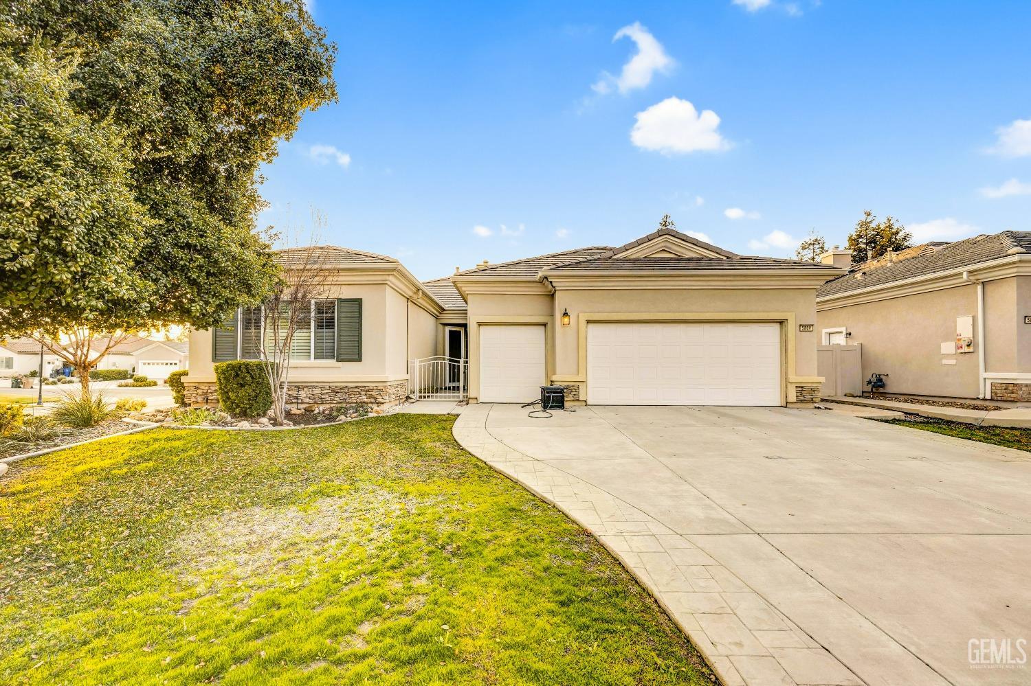 a view of a house with a yard and a garage