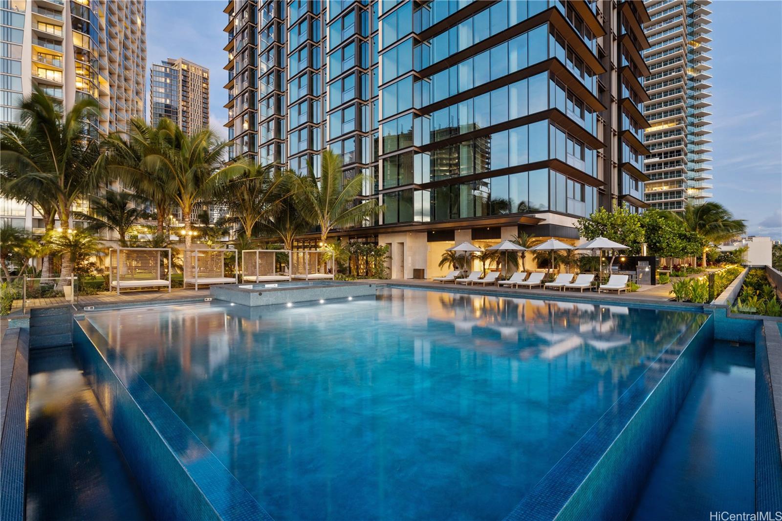 a view of swimming pool with outdoor seating and city view