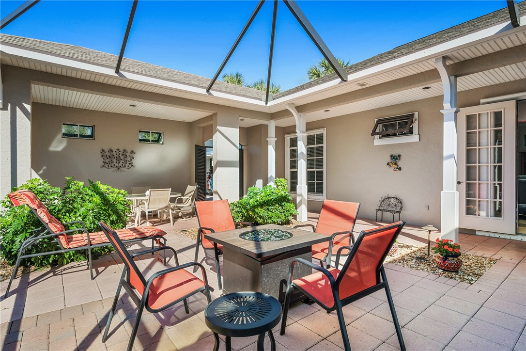 a view of a patio with table and chairs potted plants