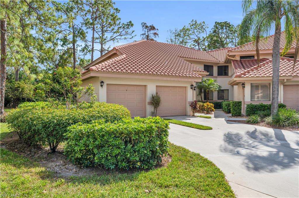 Mediterranean style coach home with a garage