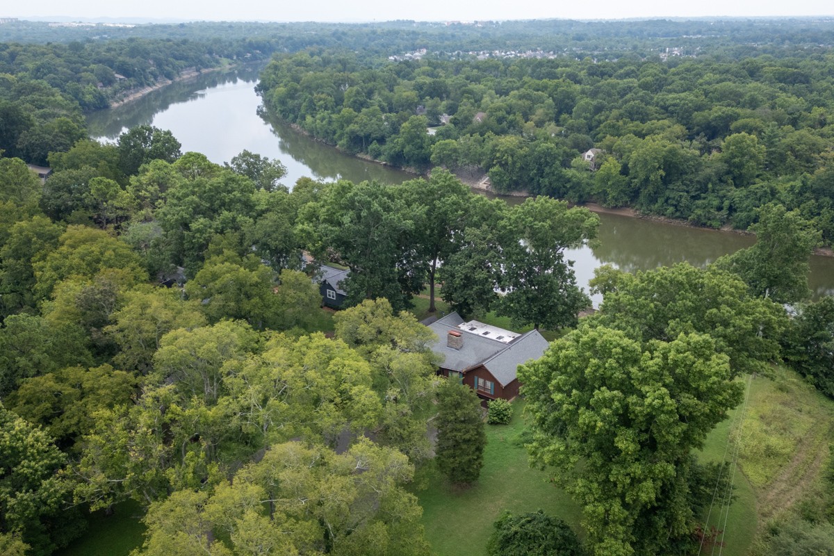 an aerial view of a house with yard