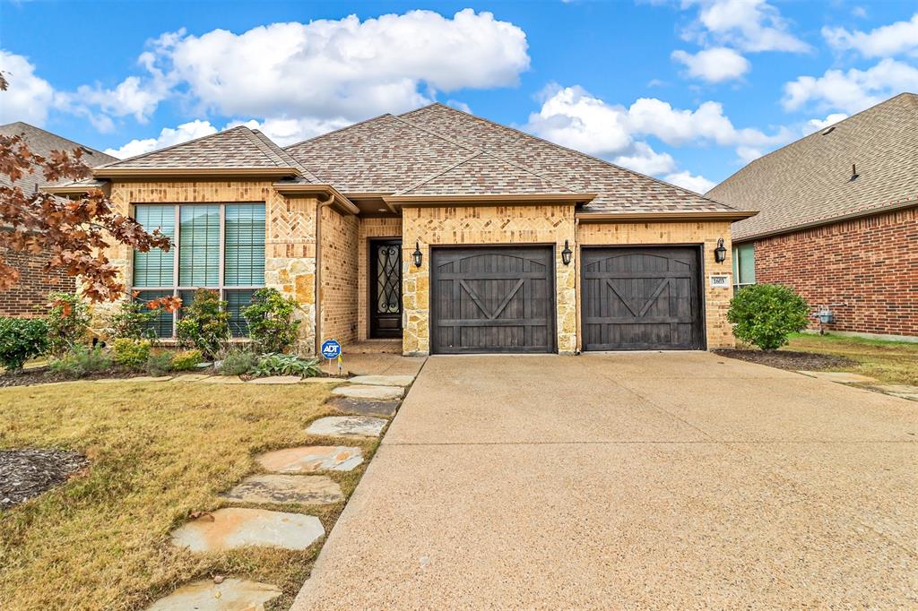 front view of a brick house with a yard