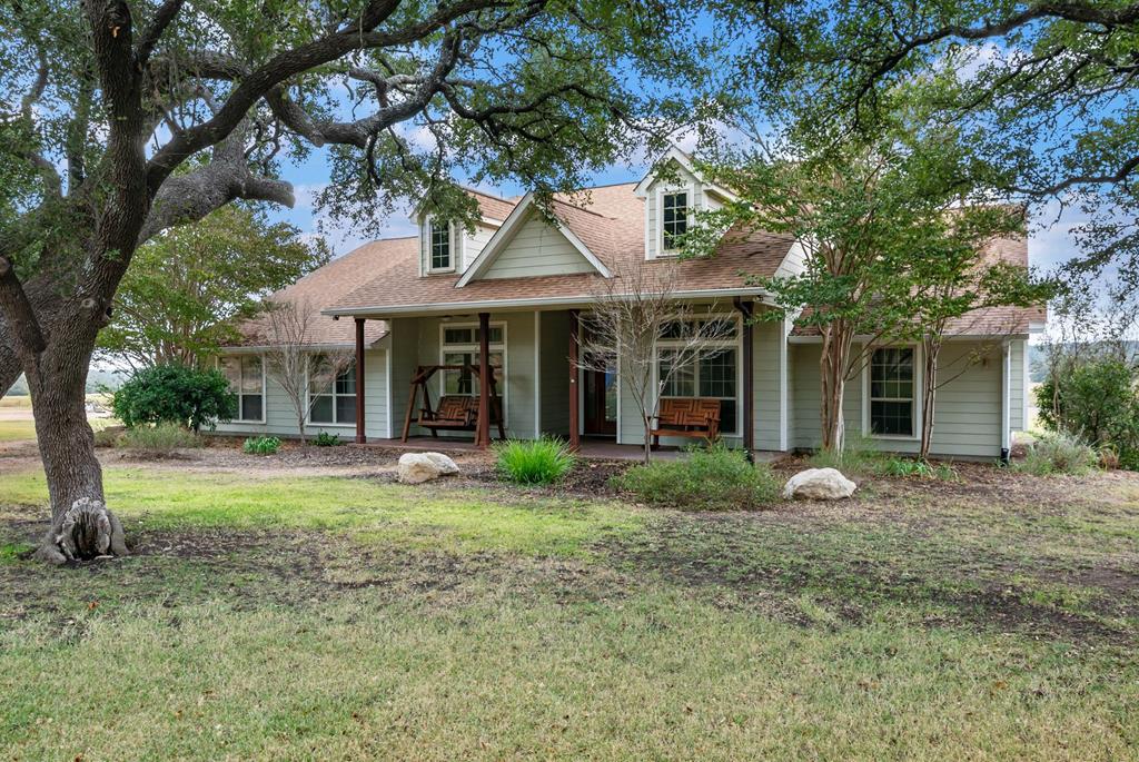 a front view of a house with garden and porch