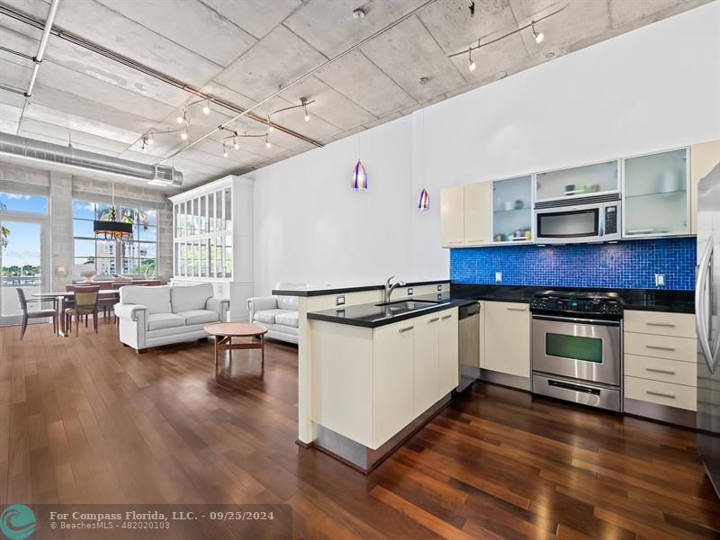 a kitchen with sink cabinets and wooden floor