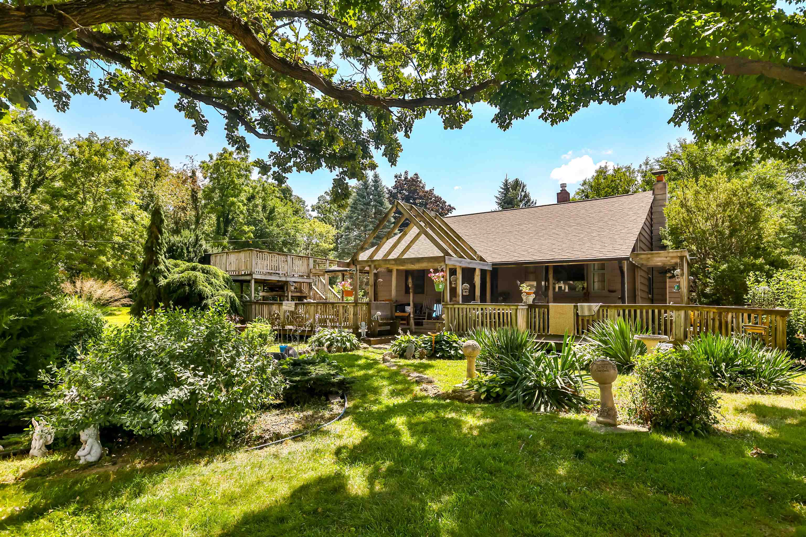 a house with green field in front of it