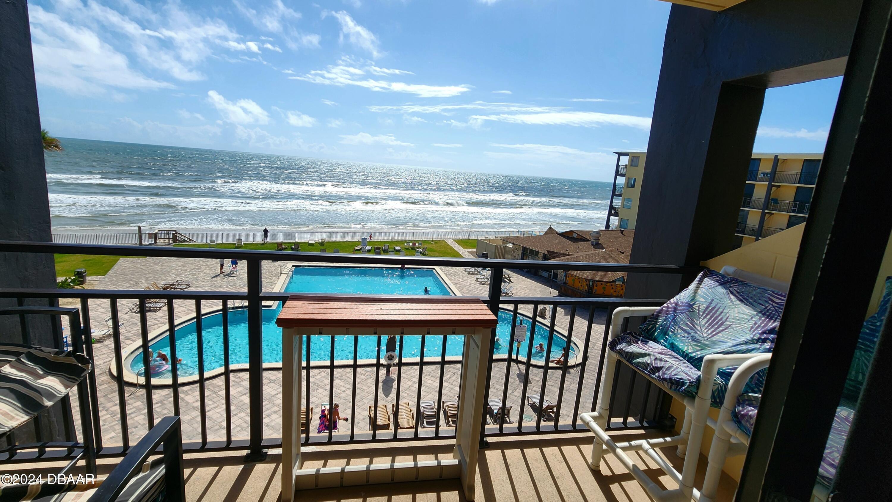 a view of a balcony with an ocean view