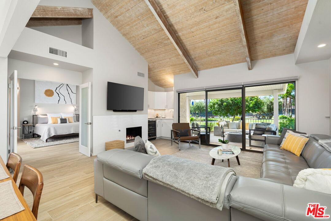 a living room with fireplace furniture and a flat screen tv