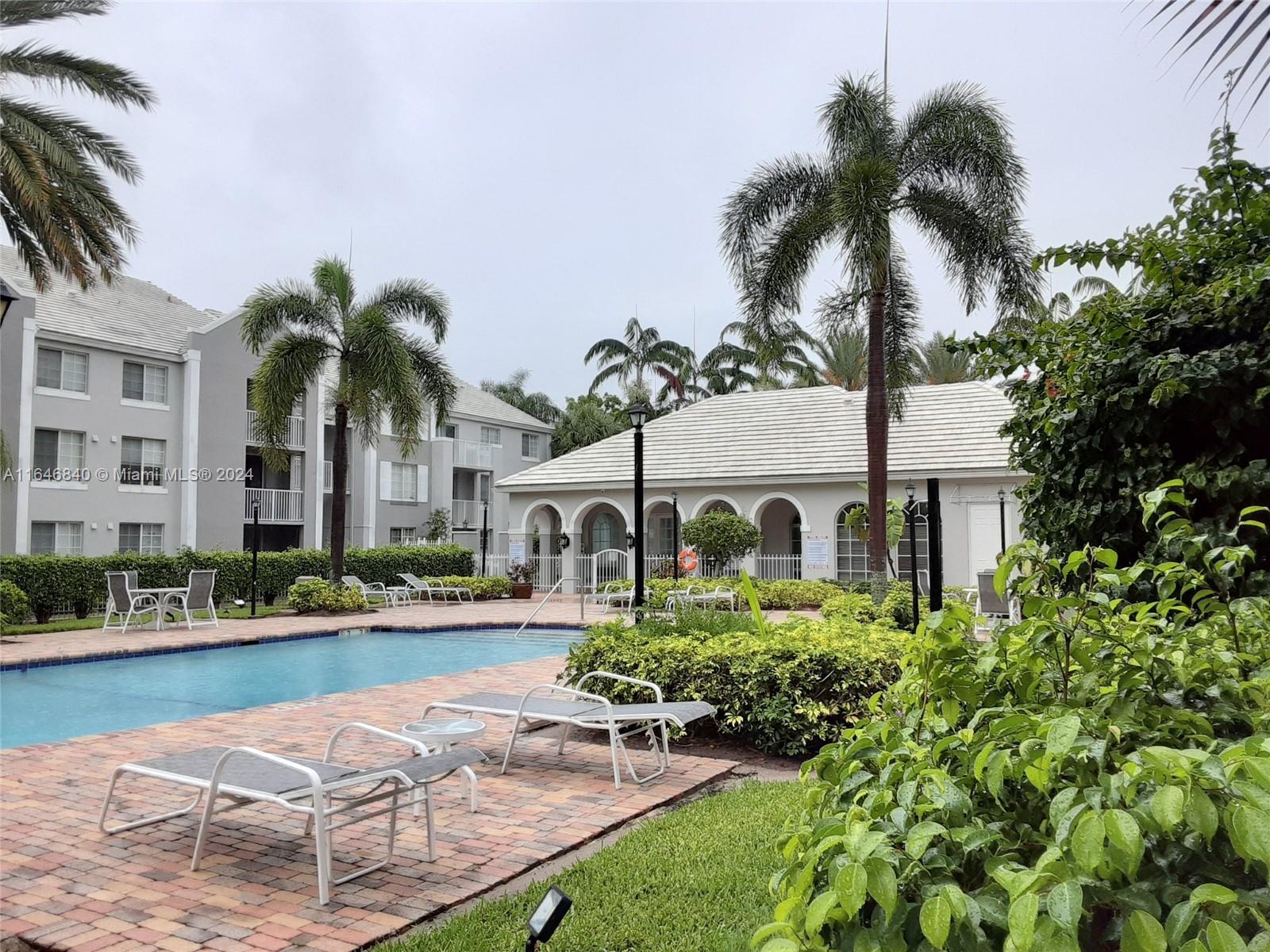 a view of house with yard and swimming pool