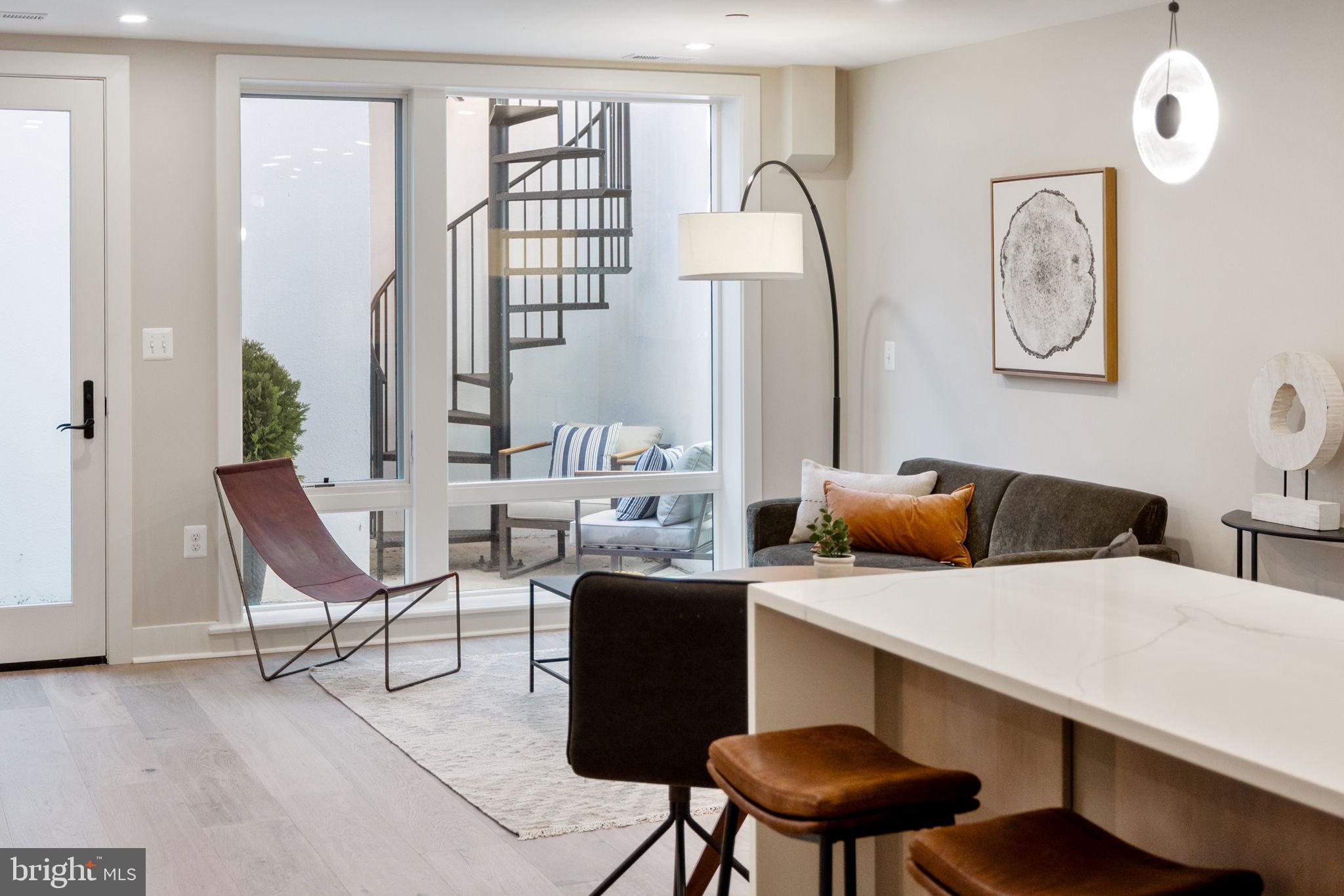 a view of a livingroom with furniture and a large window