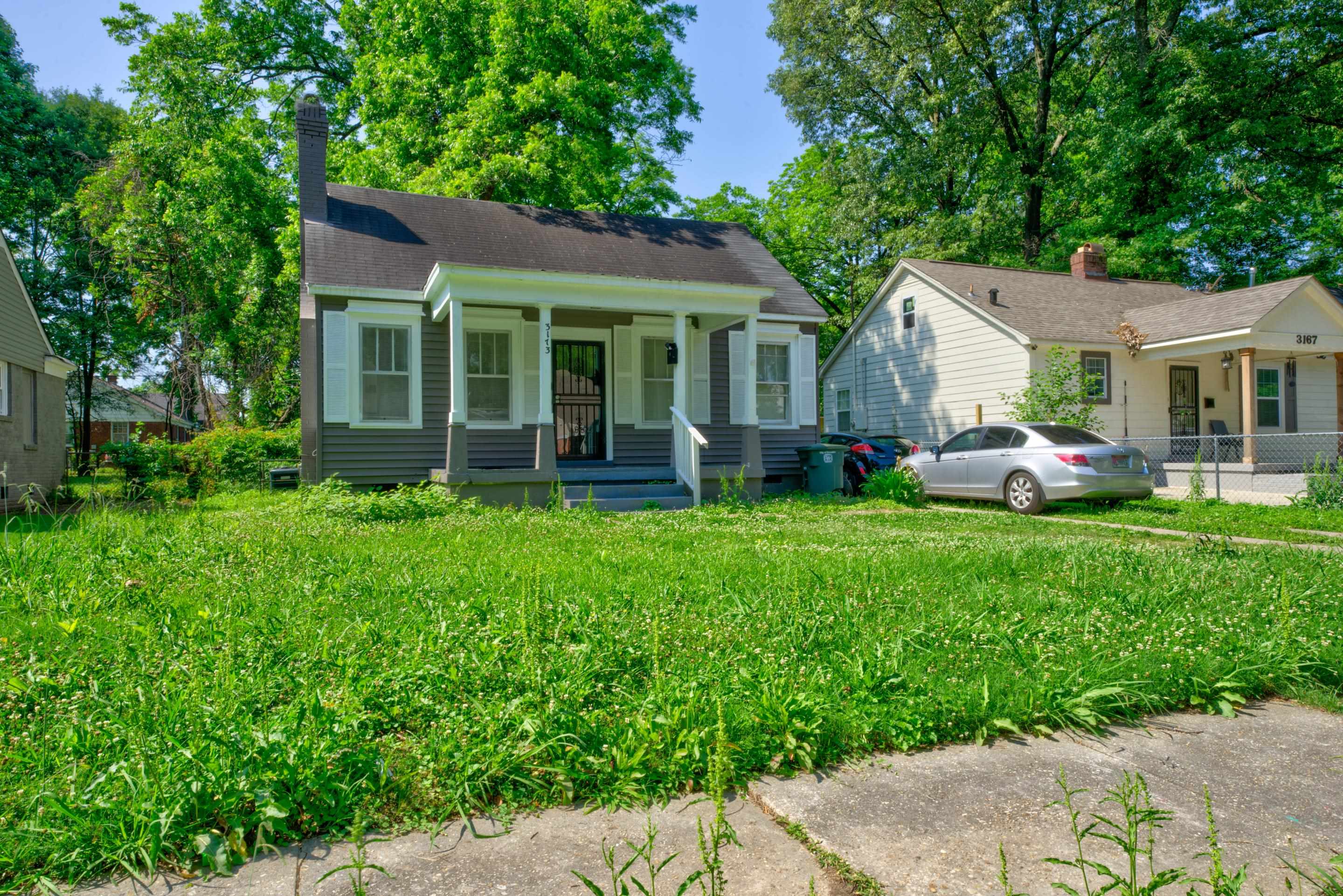 a front view of house with yard and green space