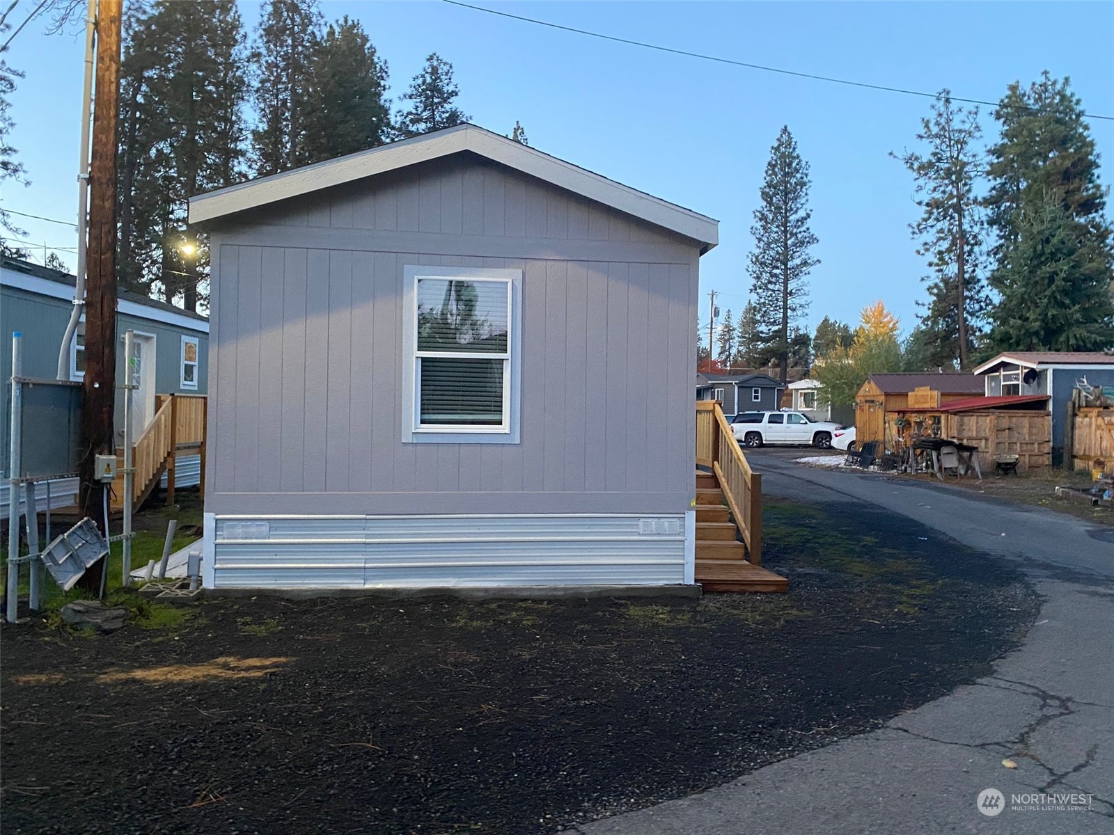 a yellow house with trees in front of it